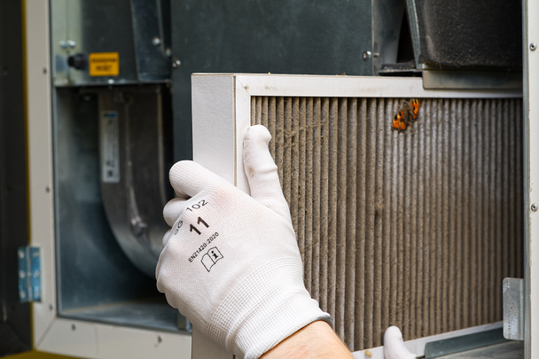 Replacing filter in the central ventilation system. hvac filter replacing home central air system Central Ventilation System